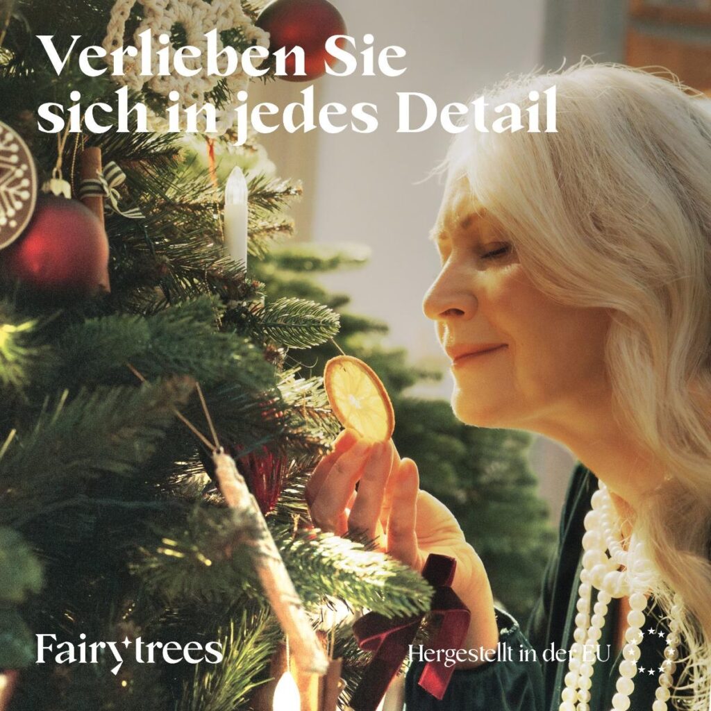 Matratzen kaufen Schweiz, Bettdecken kaufen Schweiz, Kopfkissen kaufen Schweiz Frau hängt eine Holzscheibe an die FairyTrees Nordmanntanne FT29